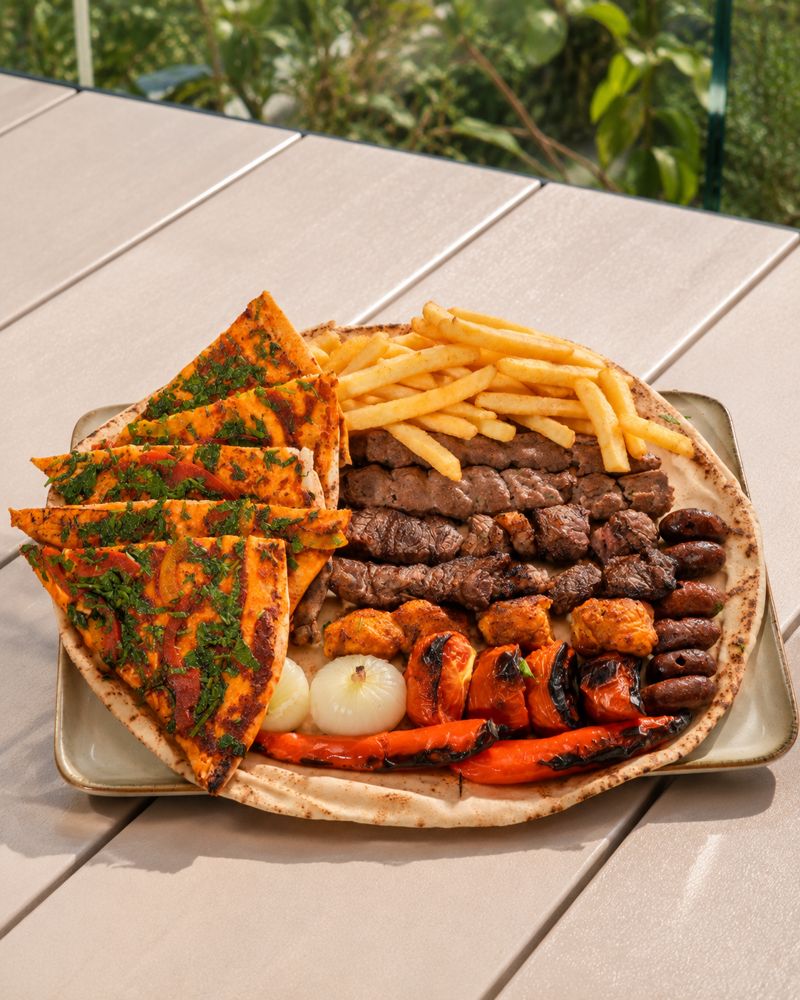 Mixed grill platter with kafta, beef, tawouk, soujok, grilled vegetables and fries