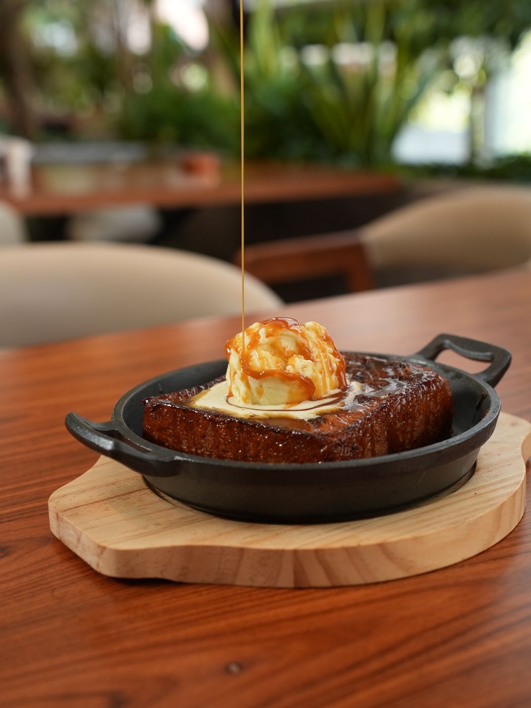 Pain perdu in a cast iron pan with vanilla ice cream and caramel